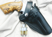 This holster from Holster Pro carries the author's favorite carrying .357 Magnum. (Note Ahrends grips.) The light weight speedloader is from Fice Star Firearms.