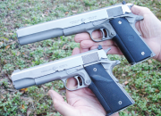 Introduced in 1977, the AMT Hardballer (held in left hand) was the first commercially-successful stainless-steel 1911 pistol. The impressive Long Slide Hardballer, with its 7-inch barrel, was introduced a few years later.
