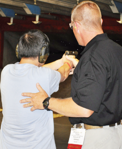 Chris working with a student to verify their ability to align sights and make a good sight picture