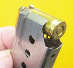 A round at the top of the back-feeding magazine