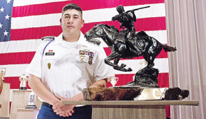 SSgt. Tyrel Cooper, USAMU, stands alongside the Tompkins Trophy at NRA’s Long Range High Power Rifle Awards Ceremony. (NRABlog photo)