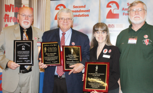 Dramatic changes in Illinois gun carry laws were the focus for award presentations at the GRPC luncheon. Shown, left to right with their awards: Don Moran, president ISRA, with SAF Defender of Liberty Award; Richard Pearson, executive director ISRA, holds CCRKBA Affiliate of the Year Award given to Illinois State Rifle Association, and his personal CCRKBA Gun Rights Activist of the Year Award, and Valinda Rowe and husband, Mike, of Illinois Carry Inc., with CCRKBA Grassroots Organization of the Year Award.