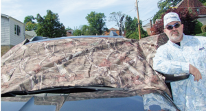 Author wearing Columbia’s Tamiami Shirt, leaning on his SUV with GetHerCovered…you can see how it extends around to the front door windows.