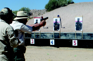 The late Mike Hughes from Gunsite looks over my shoulder while I run the Custom 14/45.