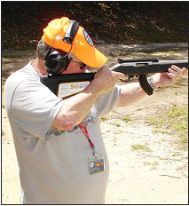 Extended ma gazines ha v e become very popular since the magazine restrictions of the “Assault Weapons Ban” have been lifted. Here, shooting companion Kirk Anderson shoots the 50th Anniversar y rifle with a long extended magazine.
