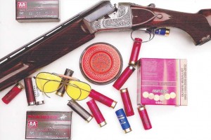 A shotgun, shells, glasses and a 2014 White Flyer target. The Clever Super Target box contains 25 shells, while the two Winchester AA Tracker boxes contain only five shells for a sample trial to permit observation of the wad flight path. 