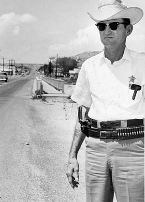 Terrell County Sheriff Bill Cooksey wearing his gun in its usual place. Photo copyright San Angelo Standard-Times, San Angelo, TX. Reprinted with permission.