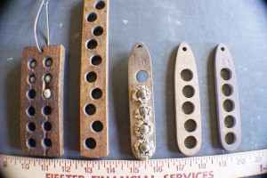 Some typical hardwood loading blocks drilled for specific calibers, left to right: 45, 50, 54, 58 and 62 calibers.
