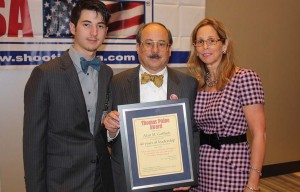 After all the other awards were announced, Alan Gottlieb (shown here center with son Andrew and wife Julianne Versnel) was presented with a new Thomas Paine Award in recognition of his 40 years of leadership after founding the Second Amendment Foundation in 1974. The award was presented by Joe and Peggy Tartaro in the name of the Second Amendment Friendship, representing everyone attending the GRPC or supporting its common gun rights purposes. (Dave Workman photo)