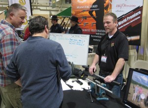 Jamie Dodson of Wolf Precision talks to potential customers. Jamie had such a good show that he had to add two additional classes to his schedule of long range shooting schools during the show to meet demand.