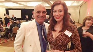 Chuck de Caro and his wife, Lynne Russell, celebrate at a CNN anniversary party in June. (CNN photo)