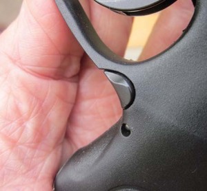 The magazine catch, at lower rear of the trigger guard, is pushed downward to release. 