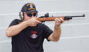 Author shooting the Ruger 10/22 Takedown while wearing Mack’s Live Fire electronic shooter’s earmuffs; having a safe, fun time at the range. 