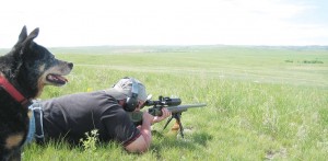 The author’s buddy Jim K. reaching out on the prairie as the author’s Heeler dog, Maggie, does the spotting. 