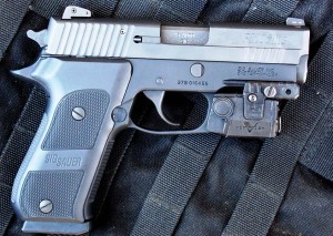 The author’s personal SIG P 220 Carry Elite, shown with Viridian combat light, has given excellent service. 
