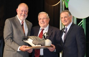 Ted Rowe honored at NSSF dinner Firearms industry veteran Ted Rowe (center) was honored for his many years of service to the firearms industry with the prestigious National Shooting Sports Foundation (NSSF) Ken Sedlecky Award during the annual “State of the Industry” banquet at the 2016 Shooting, Hunting and Outdoor Trade (SHOT) Show in Las Vegas in January. The award was presented by NSSF Board Chairman Robert Scott (left) and NSSF President Steve Sanetti (right). Rowe, who has been in the firearms industry for decades, most recently served as president of the World Forum on the Future of Sport Shooting. He was president of Harrington & Richardson Arms, then worked for Sig Arms and Ruger, and also worked for the NSSF. Now retired, Rowe received the Sedlecky Award “for his enduring commitment to the success of the industry and supporting NSSF’s mission to promote, protect and preserve hunting and the shooting sports.” 
