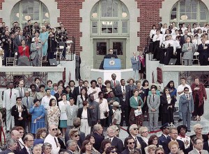 New U.S. citizens, led by Supreme Court Justice Scalia, recite the Pledge of Allegiance during the re-opening of Ellis Island in New York on Sept. 10, 1990.