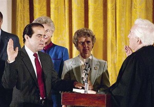 Retiring Chief Justice Warren Burger, right, administers the oath to Justice Antonin Scalia, as his wife, Maureen, holds the bible during ceremonies in the East Room of the Reagan White House, Washington on Sept. 26, 1986. 