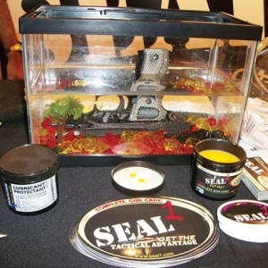 Seal 1 shows off its water-repellent lubricant by immersing a pistol in water throughout the show. 