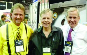 Left to right, NAA’s General Manager Ken Friel, gun guru and writer Randy Wakeman, and NAA’s President Sandy Chisholm share smiles at a previous NRA Convention. (Snappy Cappy photo)