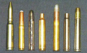 Left to right: In the Kynoch fixed ammunition and new brass for handloaders lineup: First not a cartridge but a Kynoch ballpoint pen; then a Kynoch 9mm Mauser round; plated commemorative 405 Winchester round (Theodore Roosevelt’s medicine gun cartridge); 6.5mm/378 Weatherby Magnum case; Kynoch 400 Straight 3”; plated Winchester 375 H & H Magnum case, and plated 458 Winchester Magnum cartridge. 