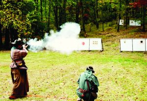 Barb and Eric Bye shooting a rifle and pistol side by side. (Jeffrey Robison photo)