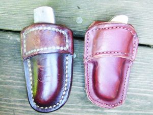 Carried in a leather belt pouch made by an Amish leather worker, the author’s knife(left) is his constant companion and has, over the years, been the subject of considerable lust from our son Brock. We have often thought we’d buy a similar knife for Brock but finding one had seemed a daunting task, until he found the African Custom Knife Company. Now he’s got a duplicate knife and a duplicate belt pouch.