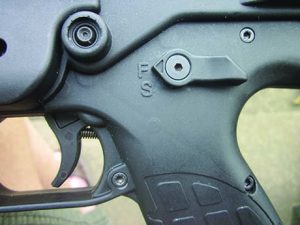 The magazine release lever is centrally located at the front of the magazine housing.