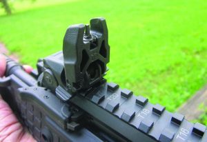 The Magpul sights that were used spring into the vertical position when the pedal is depressed.