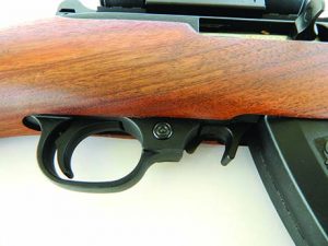The push button safety and magazine release lever are standard issue Ruger 10/22 type. 