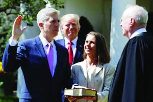 President Donald Trump watches as Supreme Court Justice Anthony Kennedy administers the judicial oath to Judge Neil Gorsuch during a re-enactment in the Rose Garden of the White House White House in Washington April 10. Holding the bible is Gorsuch’s wife Marie Louise Gorsuch. (AP Photo/Evan Vucci) 