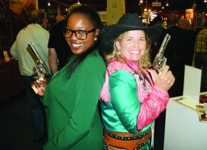 Two-time World Champion Gun Twirler Paula Slaetnik (right) was also the first female champion. Slaetnik posed with author’s companion, Shauna Washington, left, at the Cimarron Firearms booth.