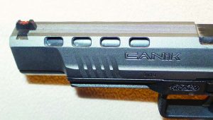 To reduce slide mass and felt recoil, Canik puts 10 cut outs in the slide, 2 are under the front of the slide; 4 on each side.