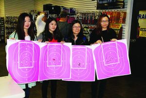 Four participants hold up pretty impressive targets at the sixth annual free firearms safety event organized by Legally Armed in Detroit.