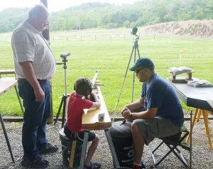 At a Table Shoot at the NMLRA range, left to right, Grandfather Don Blazier, Grandson Lucas Fulmer and Dad Curt Fulmer.