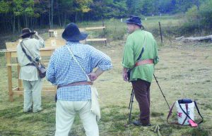 Left to right, Kurt Burket loading, Wes Griest scoring and Mike Wengert spotting. The long range targets at NMLRA Rifle Frolic can be seen in the background. Farthest shot is General Frazier then four targets for the Lt. Ephriam Brank match each getting closer.