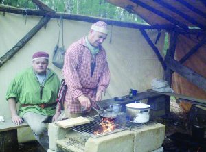 The “Squirrel Shack” with raised hearth; Mike Wengert, left, and Norm Hoover cooking.
