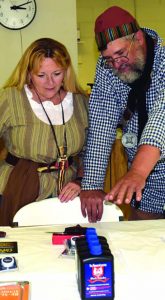 Left, Past President NMLRA Becky Waterman picking a prize with author, 