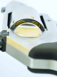 Cartridge case rims are visible beside the recoil shield.