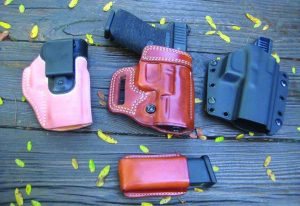 Three options for the carrying the Glock 19 from Galco. Left to right; The Scout 2 IWB in horsehide, the Avenger, and the Corvus Belt/IWB convertible in Kydex. Mag pouch is the Concealable. 