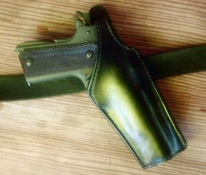 A close-up of El Paso Saddlery’s #2 police duty crossdraw holster on a belt showing it’s position for a fast draw.