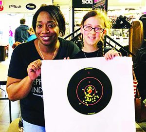Firearms trainer TaNisha Moner admires the target of the 12-year-old who was the youngest participant in the 2018 handgun safety and familiarization class in Detroit. The oldest was an 87-year-old.