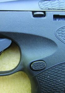 The slide latch and magazine release are in the usual locations. The takedown latch is on the right side above the trigger.
