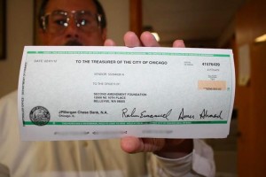 SAF Founder Alan Gottlieb holds up a check from the City of Chicago after the McDonald v. Chicago Supreme Court decision.