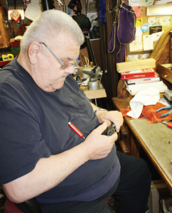 Gunsmith Tim McCullough is shown hand-fitting the slide and frame of a Lightweight Commander “project gun” he put together from parts.