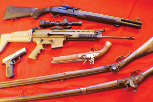 3-Gun competition essentials, then and now! Top Down: FN SLP 12-gauge shotgun; Scar 16E FDE rifle; FN-9 DA pistol; .69-cal. Tower pistol; .45-cal. Lancaster rifle, and .69 cal Charlesville smoothbore.