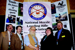 Shown at an NMLRA SHOT Show booth, left to right, are Past President Marty Murphy, Field Rep Eric Bye, Board member Kenyon Simpson, Director of Publications Terri Trowbridge, and Longhunter Chairman Dave Ehrig.
