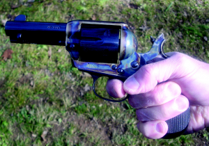 The gunfighter’s secret grip. The hammer spur is digging into the top of the hand. The center of the palm is against the back strap of the gun with the thumb and the ball of the hand at the base of the trigger finger angling down and squeezing the flat logo panels at the top of the grip. The trigger finger has the first joint curled around the trigger while the tip of the trigger finger is touching the tip of the thumb. Squeezing the flat logo panels while squeezing the trigger aligns the sights with whatever you are pointing at and converts the normally disruptive force of pulling the trigger into a steadying force. You can hit with this pistol as good as you can with a ’73 or ’92 Winchester at all ranges this way.
